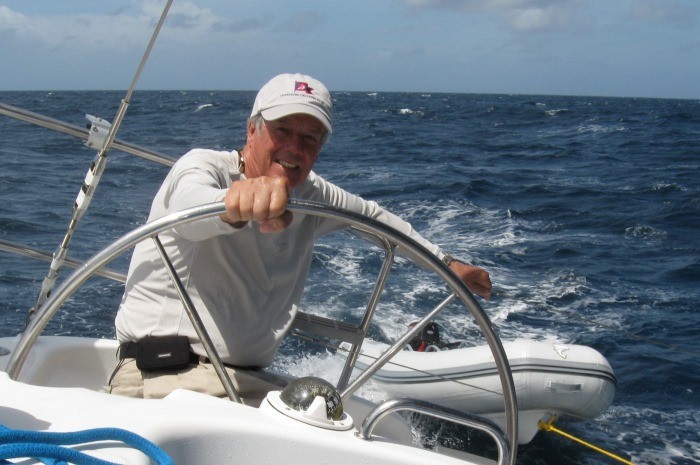 Steve Colgate steering a boat 