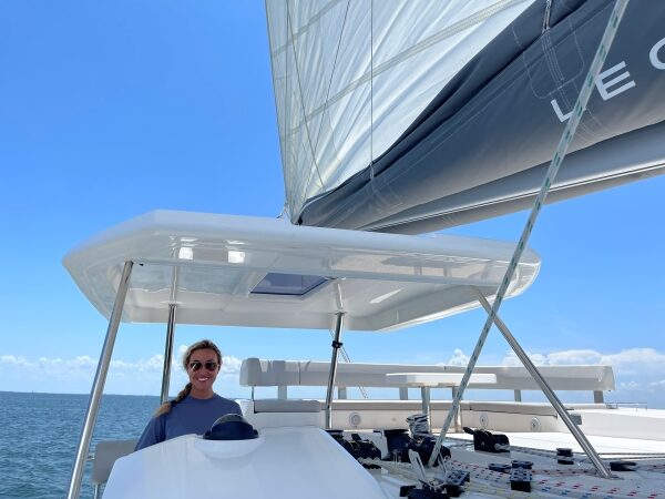 Zoe at helm of catamaran