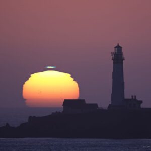"Green Flash" sighting above huge image of sun with lighthouse in foreground