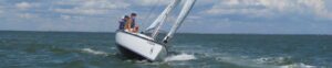 Two friends on a boat riding a wave
