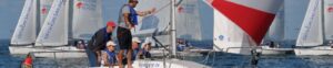 Students standing on a boat with a background of the dock