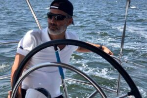 Aaron steering a boat