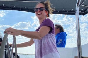 A woman steering catamaran