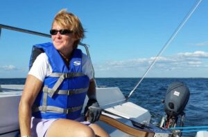 Woman at the helm of a boat