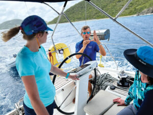 Sailing instructor teaching two women