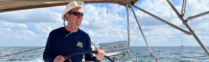 Man steering a sailboat