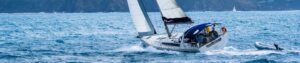 Monohull cruising sailboat in blue water
