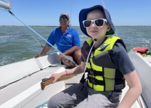 Bob Batts son learning to sail with Offshore Sailing School instructor
