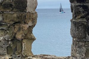 Antigua fort with sailboat in distance