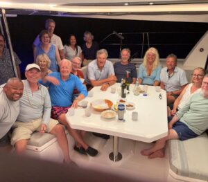 15 people in the cockpit of a sailboat