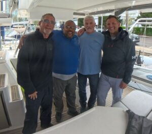 three men with Offshore Sailing School instructor on a sailboat