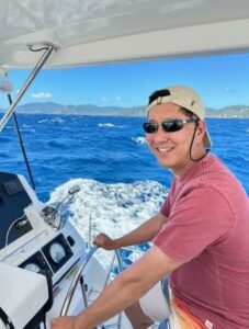 Young man steering a big boat